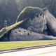 Illustration for article titled Scary giant man crawls out from the ground in shocking outdoor sculpture